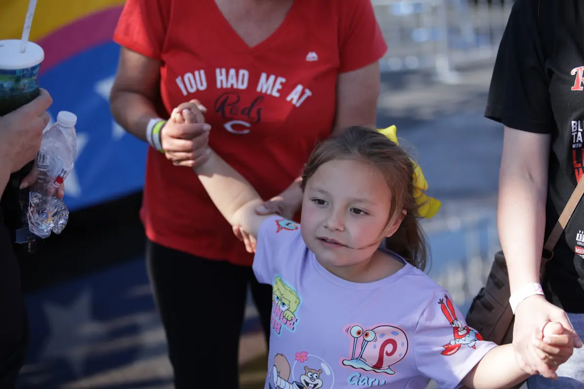 Krymsyn holding hands with family at an outdoor event