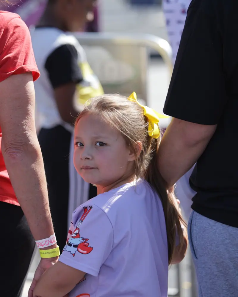 Krymsyn looking back while walking through an outdoor event